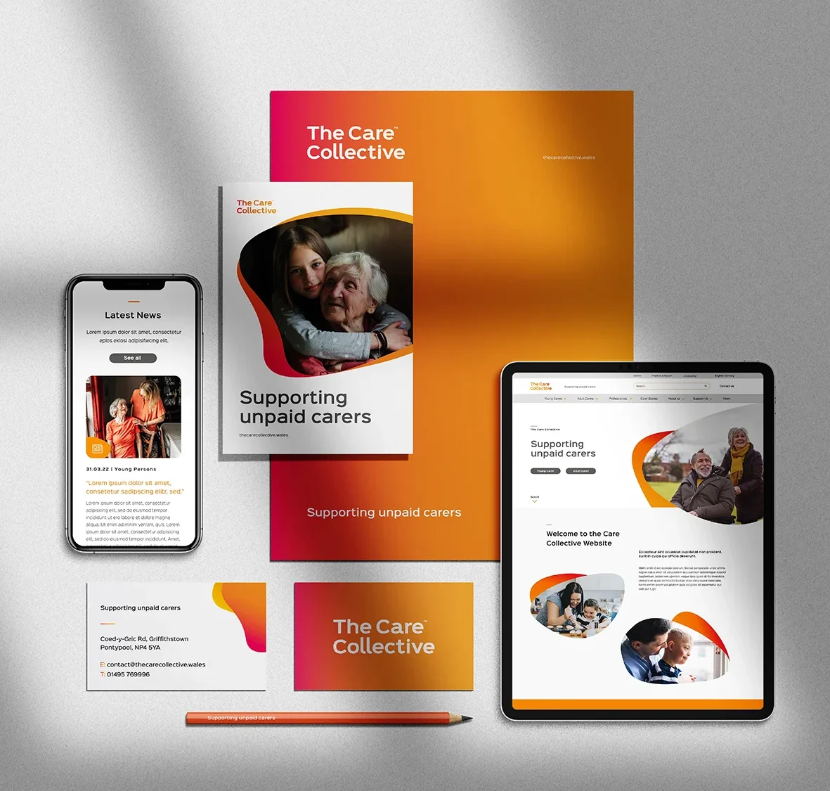 A collection of promotional materials for the care collective, featuring a smartphone, a tablet, brochures, and sheets updated with brand design elements and supporting information for unpaid carers.