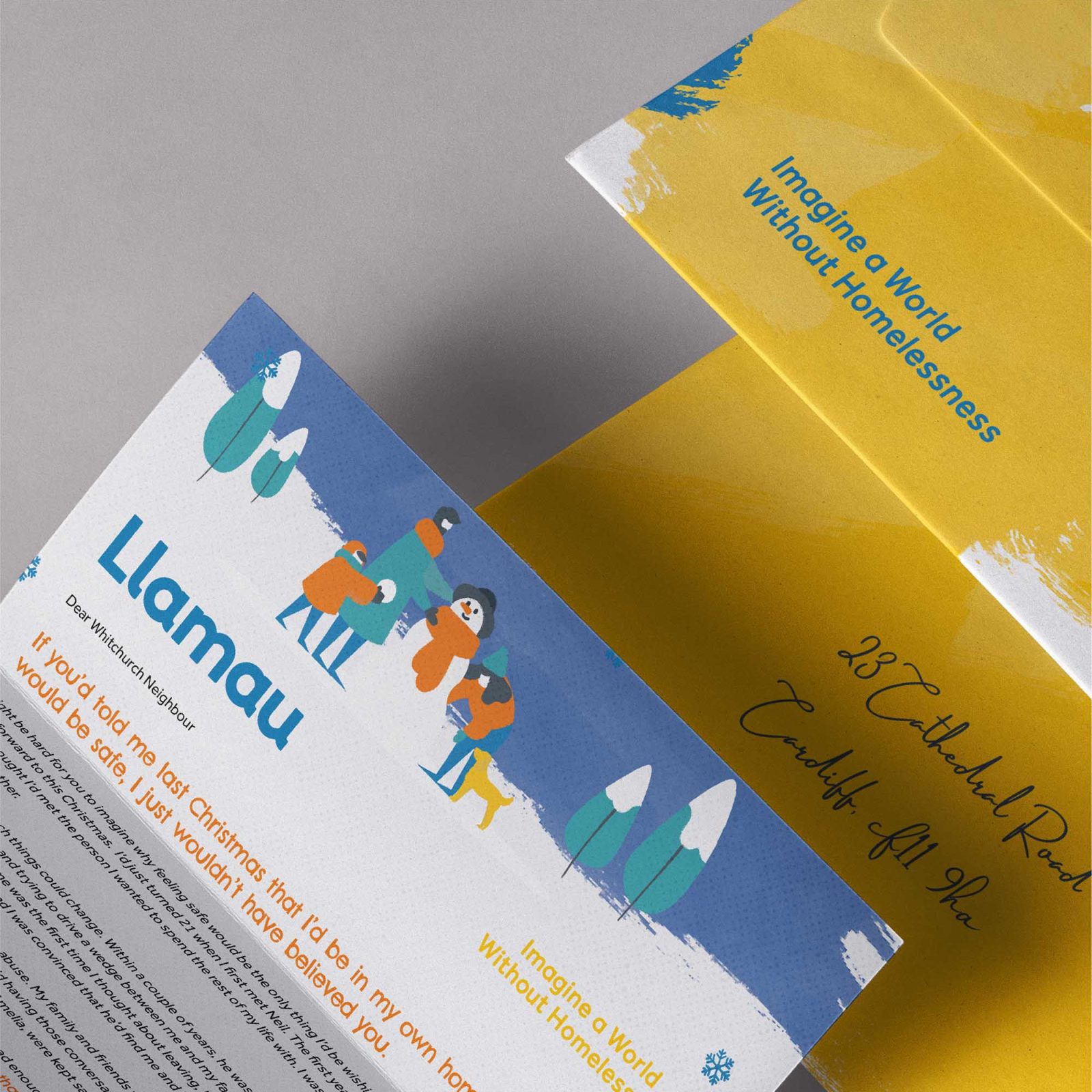 A promotional flyer for Llamau, a design agency addressing homelessness, displayed partially underneath a golden envelope. The visible part includes cartoon illustrations of people and descriptive text.
