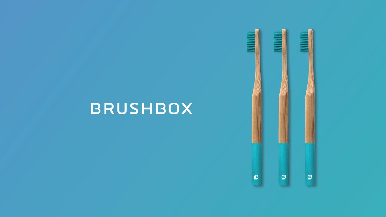 Three bamboo toothbrushes with blue handles lie horizontally on a teal background, labeled 