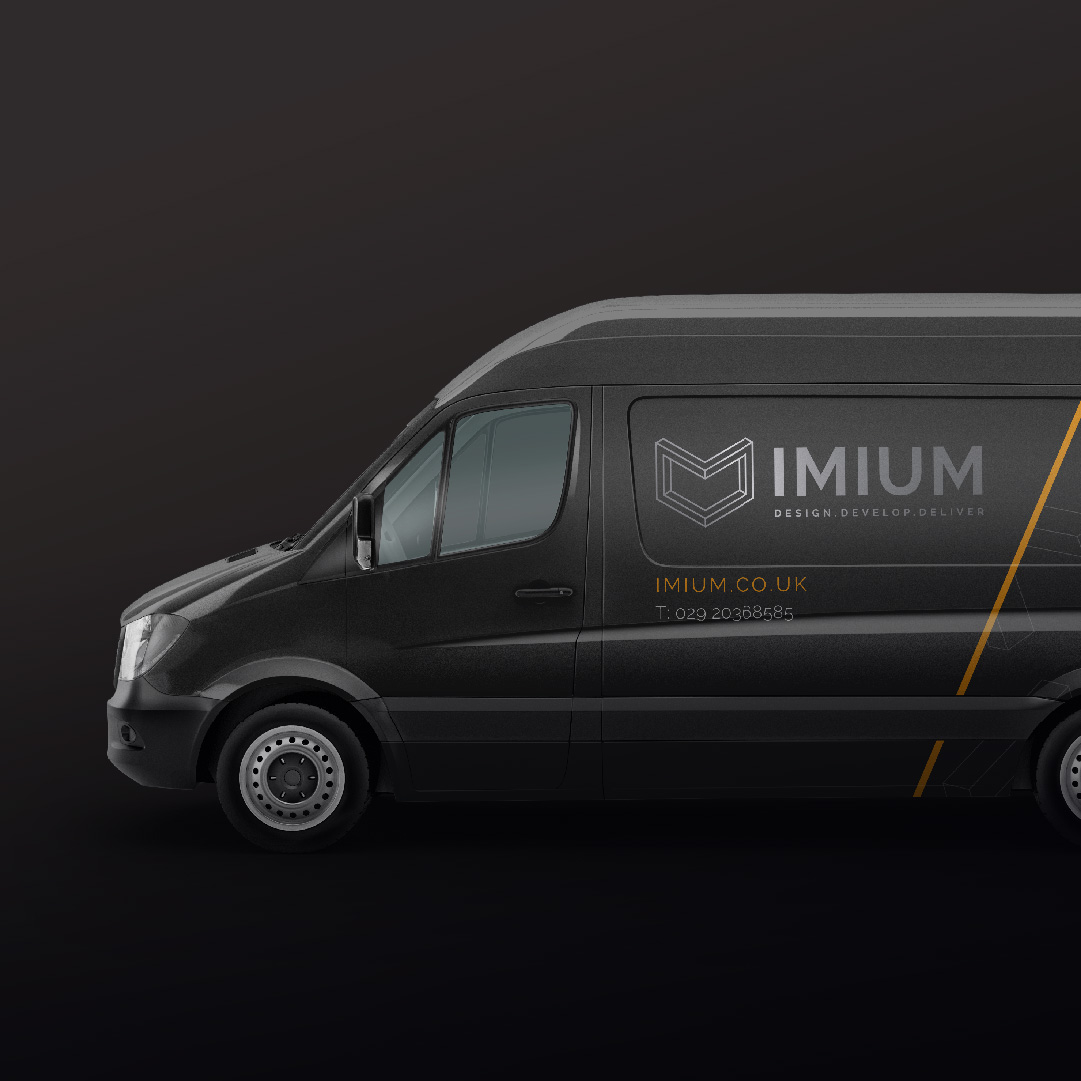 A dark gray delivery van with the logo 