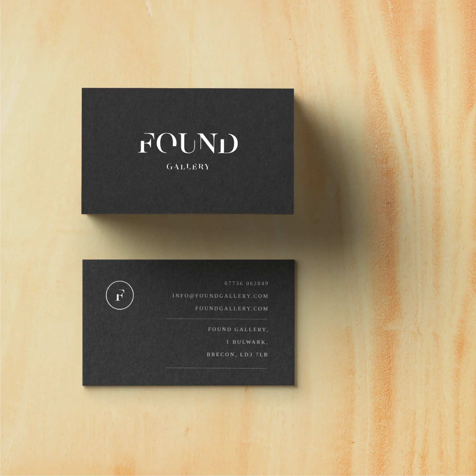 Two black business cards for 