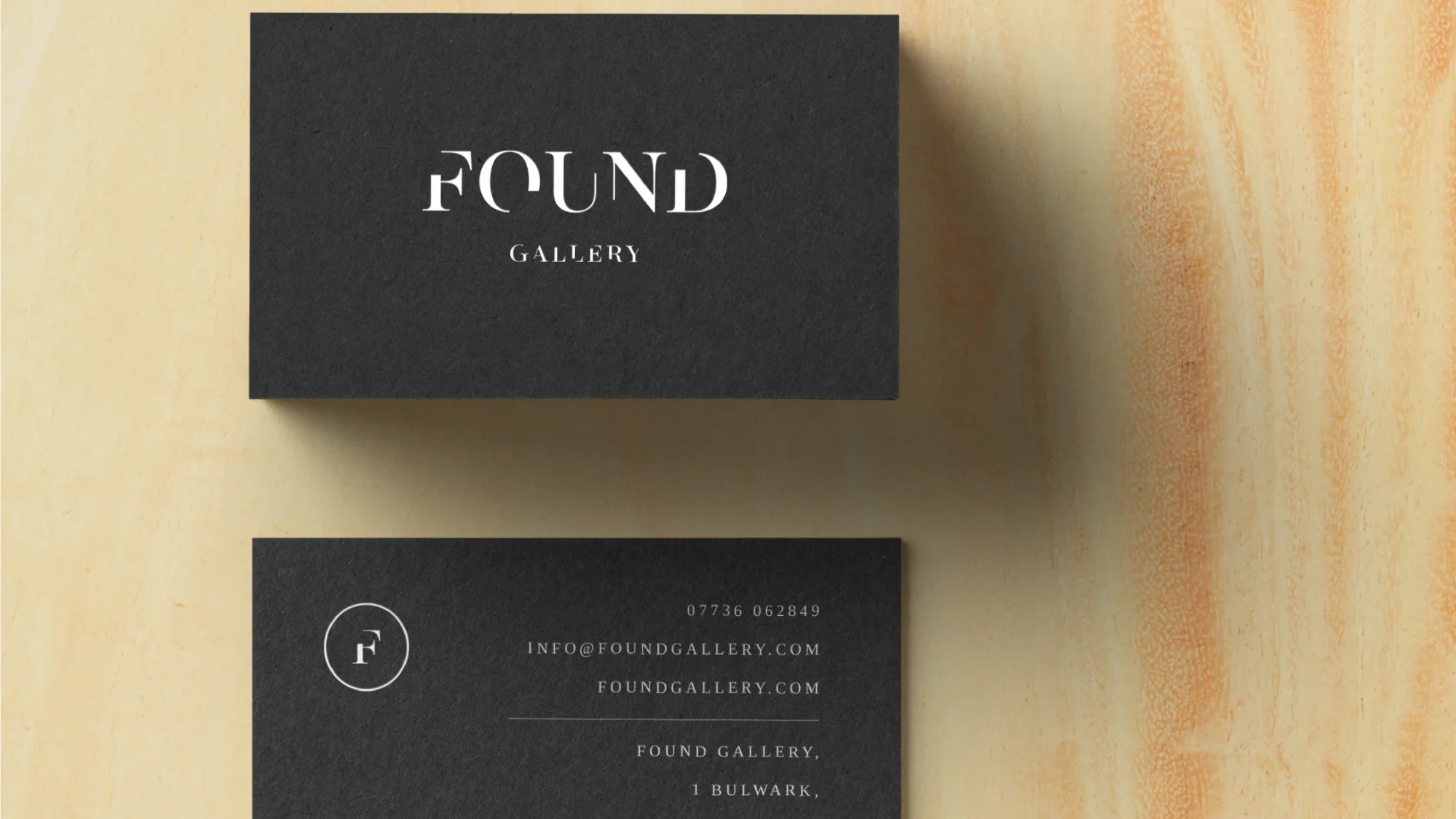 Two black business cards for 