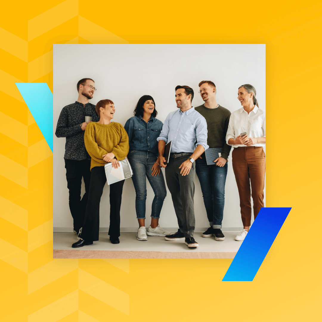 A group of six diverse people smiling and interacting in a casual office setting at a Brand Agency UK, against a light yellow background with blue and yellow geometric shapes.