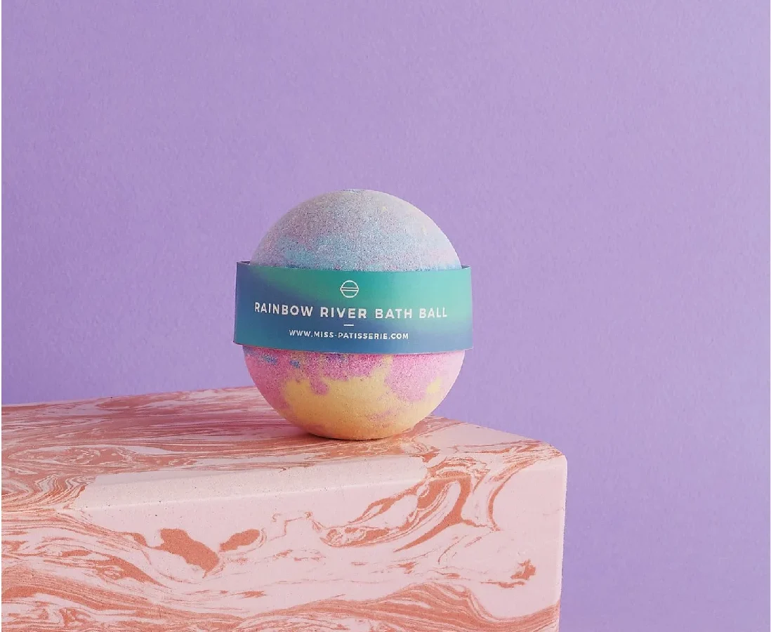 A colorful bath bomb labeled 