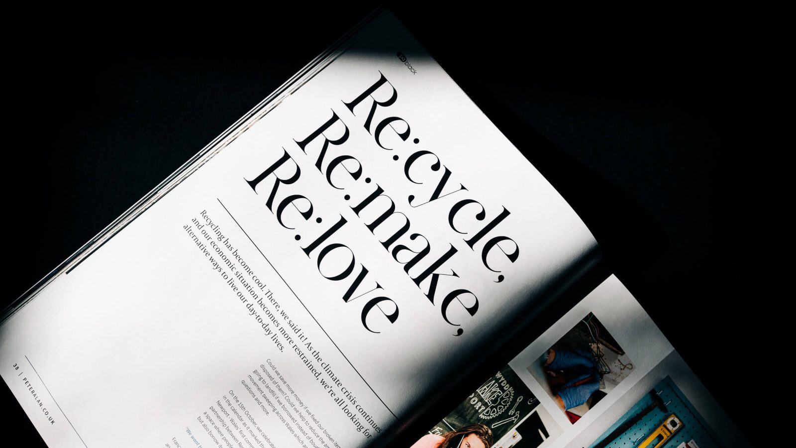 A magazine page open on a dark surface, prominently displaying the words 