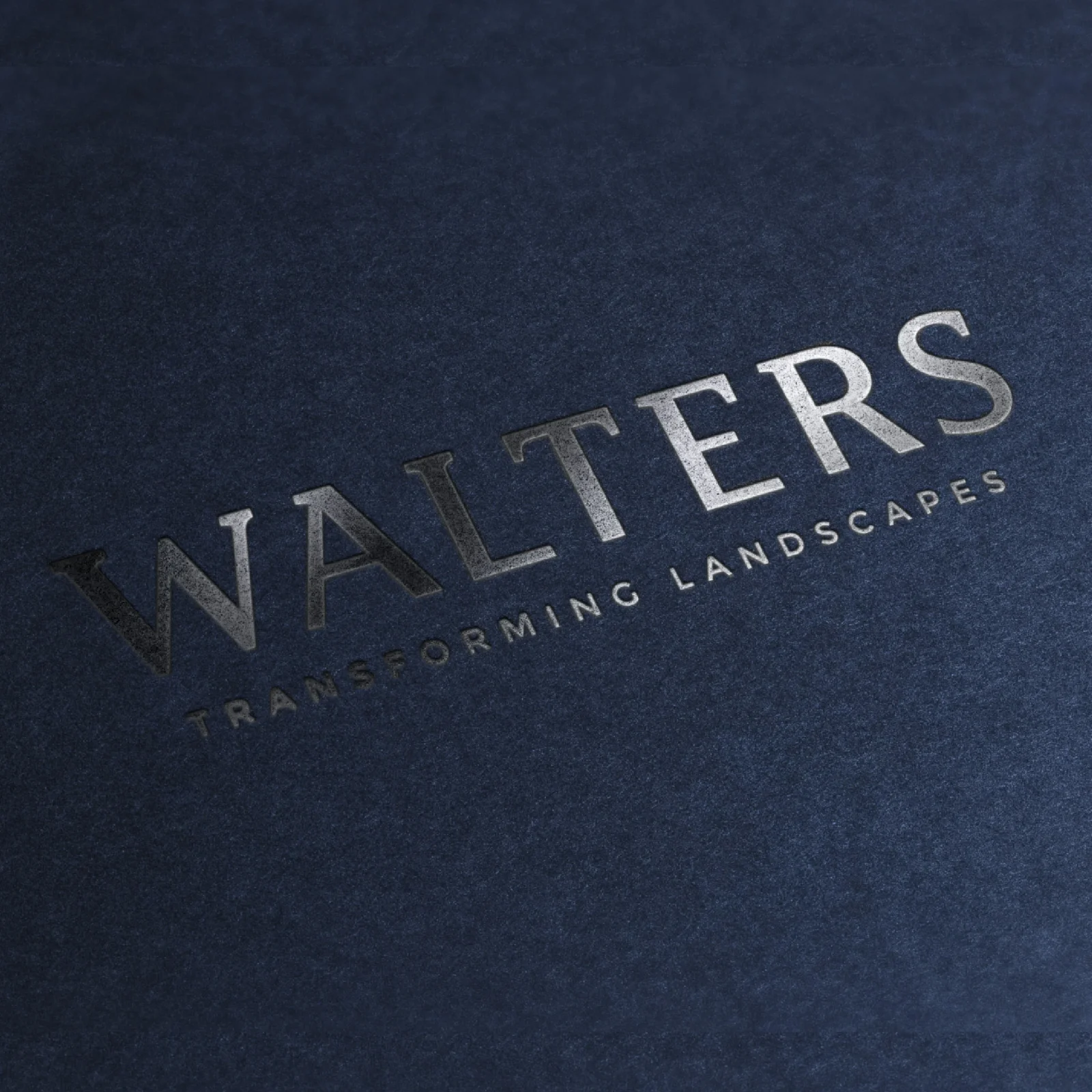 Close-up of a logo for a design agency with embossed letters that read 