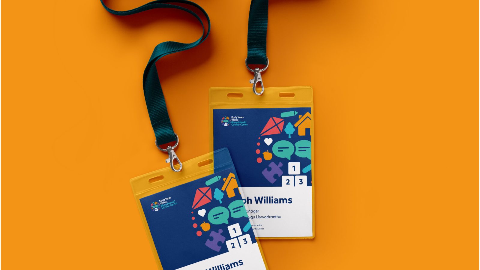 Three conference badges with lanyards on an orange background, featuring names and QR codes, designed by a Design Agency UK in blue and orange with graphical elements.
