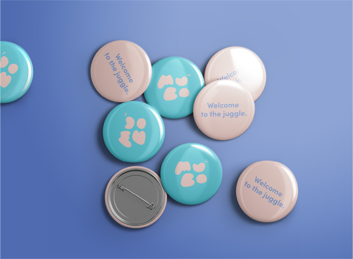 A collection of pastel-colored pin badges with paw prints and the brand design 
