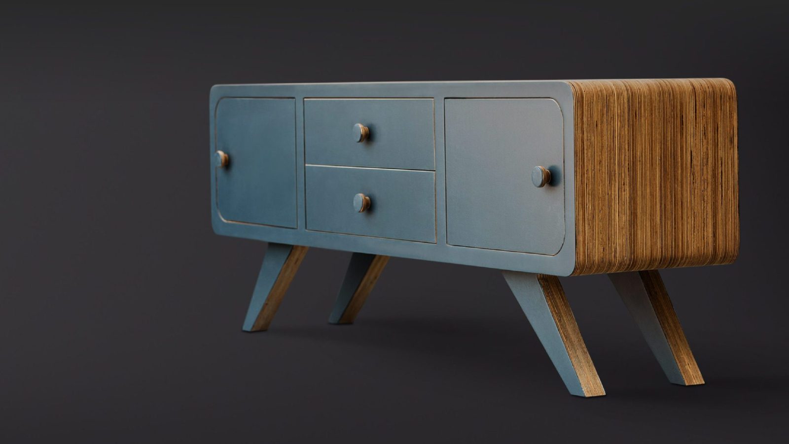 A modern sideboard with a wooden finish and three blue drawers, set against a dark gray background. Designed by Design Agency Bristol, the furniture features a minimalist design with angled legs.