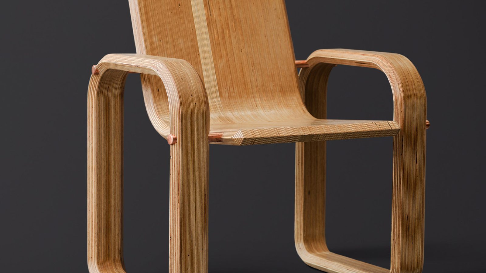 A modern wooden chair with a streamlined design, featuring smooth curves and a continuous piece for the arms and legs against a dark background, meticulously crafted by a leading Design Agency UK.