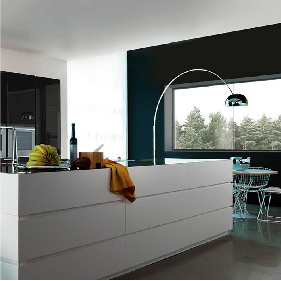 Modern kitchen interior with sleek white cabinetry, a large window overlooking a forest, and an arched floor lamp over an island. The decor includes a bowl of lemons and minimalist graphic design