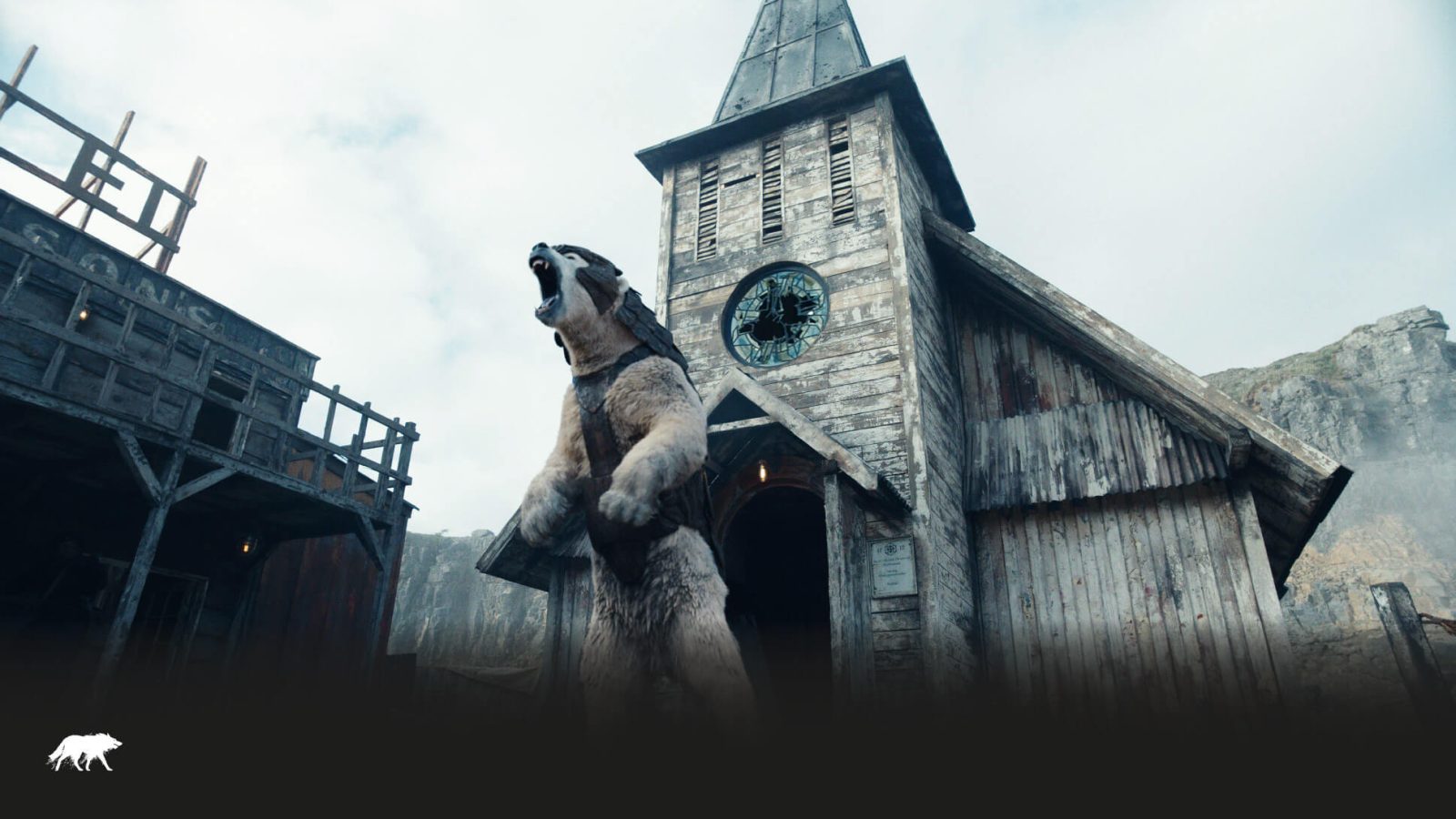 A large, animated polar bear stands on its hind legs, roaring in front of a rustic wooden building with a clock tower, set in a misty, mountainous landscape designed by a top web design