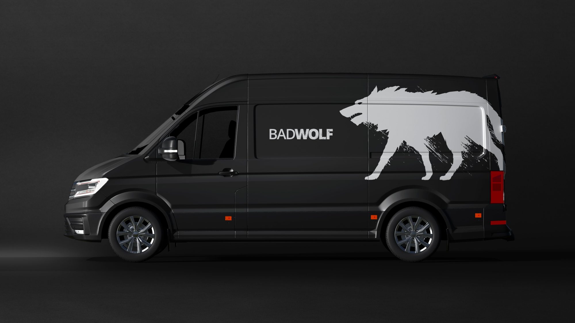 A black van parked against a dark background, featuring a large white wolf graphic and the text 