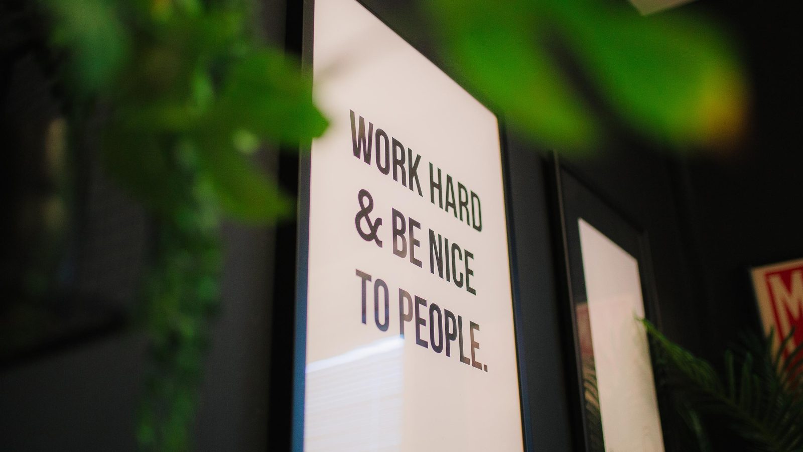 A motivational poster hanging on a wall with the phrase 